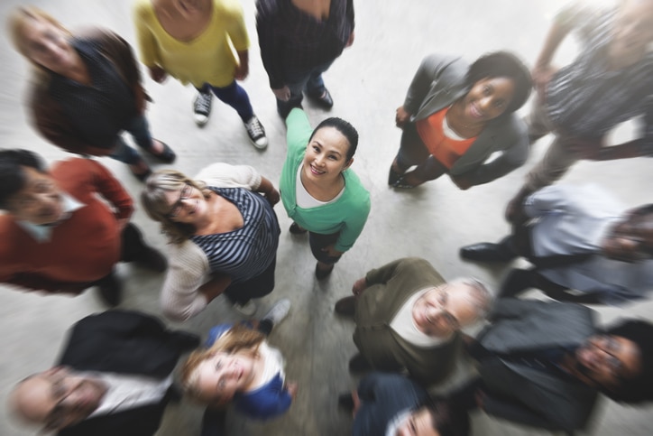 Photograph of a group of colleagues looking up into the camera