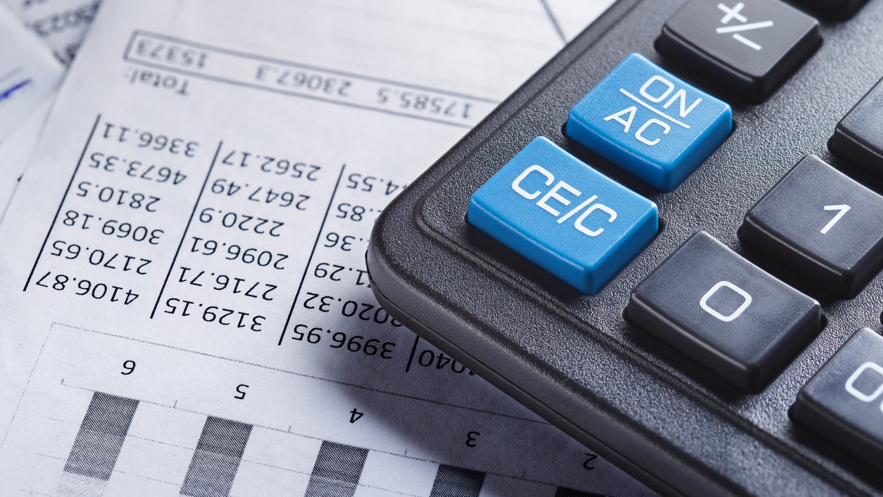Close up of part of calculator and some financial documents